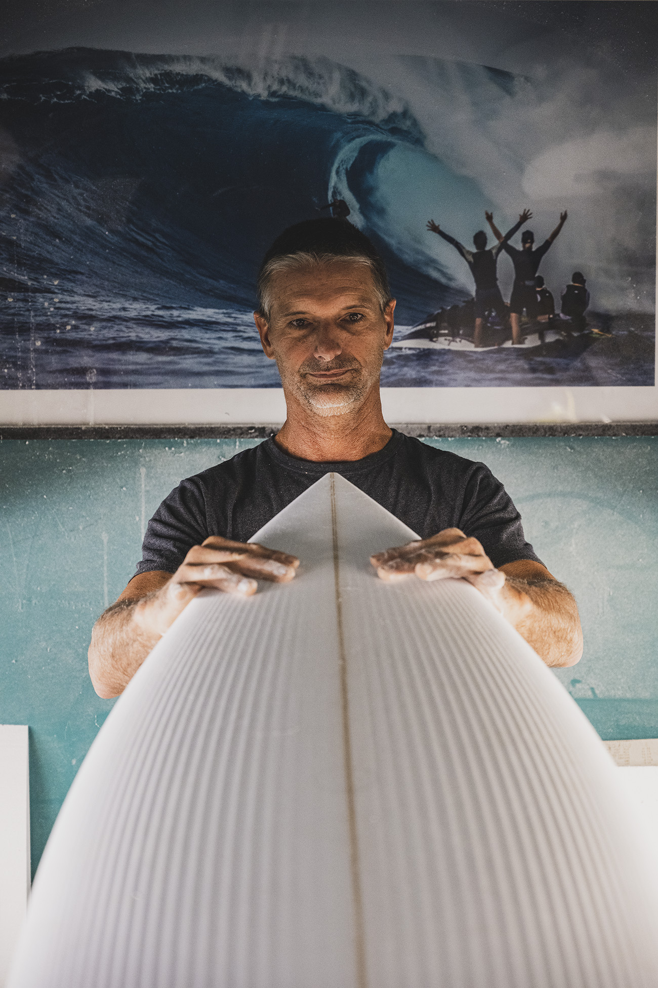 Sean behind a freshly shaped board in his Maui shaping bay